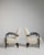 A pair of armchairs influenced by late Art Deco styling, with rounded forms and a focus on comfort. The streamlined shapes...