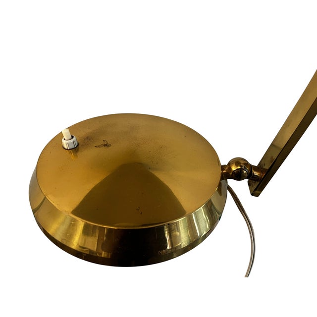 A beautiful table lamp in a very high quality design from the 1960s. The base of the lamp is round and made of brass, the...