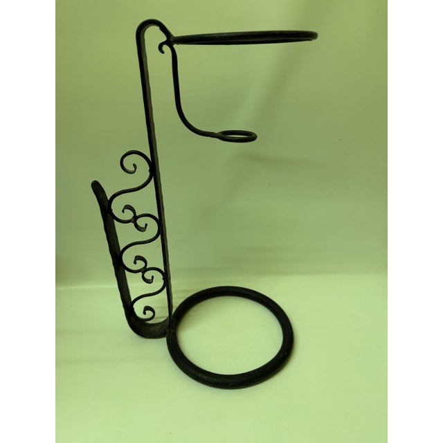 Add a striking note of musical novelty to your home bar or tabletop with this vintage mid-century wrought iron wine bottle...