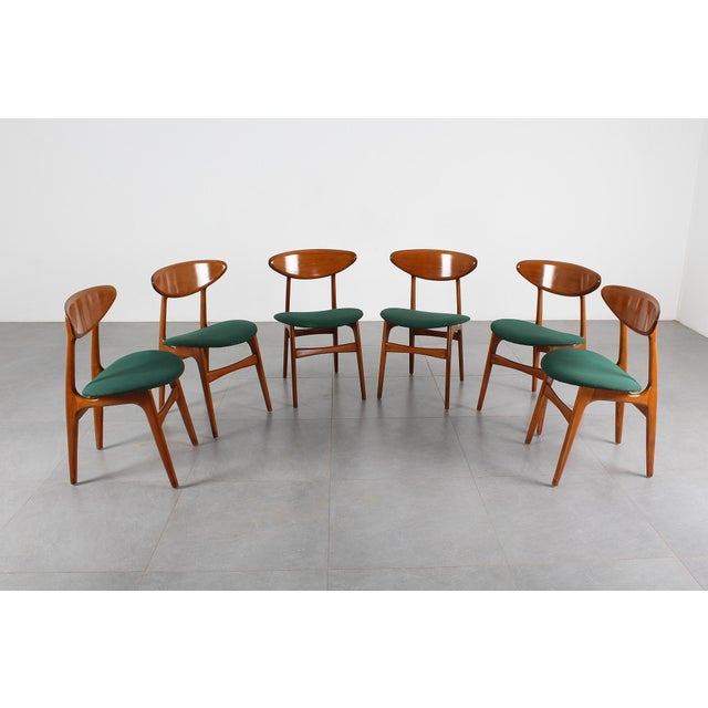 Set of six solid wood chairs with green fabric-upholstered seats. Scandinavian production from the 1960s. Wear consistent...