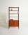 Teak bookcase with black lacquered frame and storage compartment with sliding doors. "Variett" model designed by Bertil...