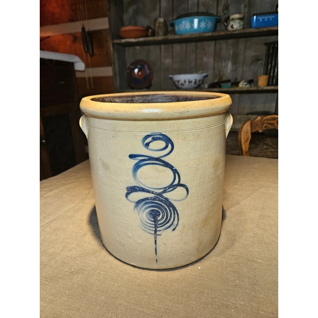 This antique salt-glazed stoneware crock showcases a cobalt blue hand-painted design, often called a "bee sting" pattern....