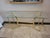 This contemporary console table features a clear rectangular glass top resting on a striking gold‑finished metal base with...