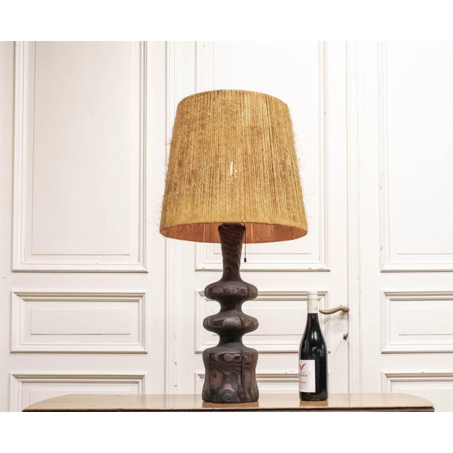 A striking Danish Brutalist table lamp from the 1960s, crafted from sculptural driftwood with beautifully weathered grain...