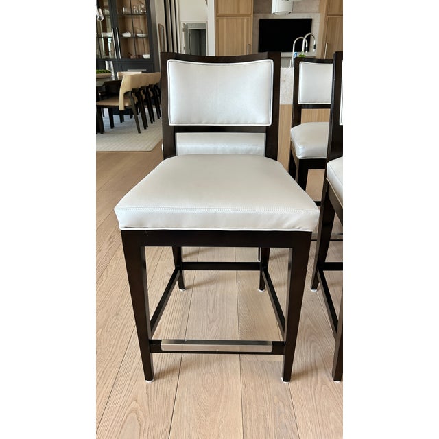 Custom counter height stools from Century Furniture. Produced in 2024, these eight (8) counter stools are made of solid...