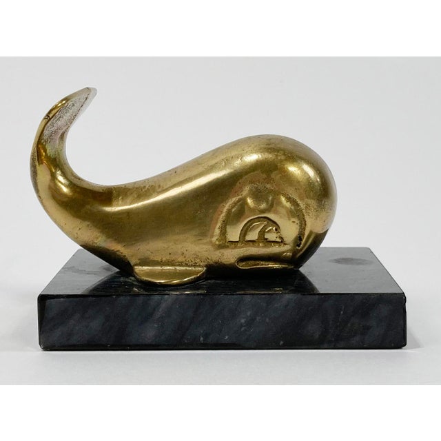 Vintage MCM style brass whale on solid marble base. Makes for perfect paper weight or decorative accessory. Patina to...