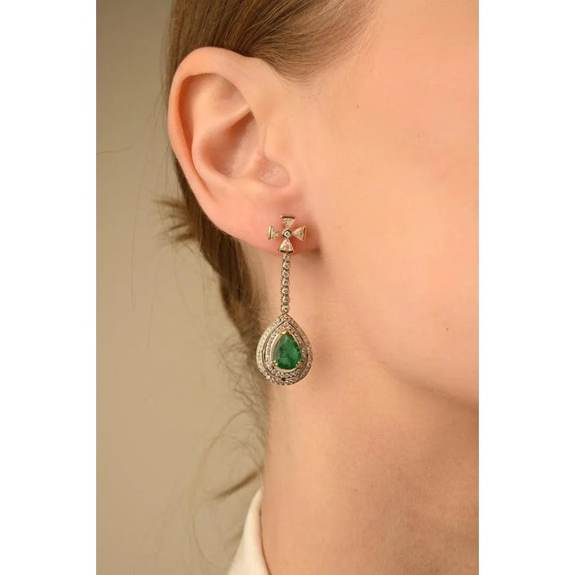 Emerald Dangle Drop Earrings in 14K Gold with Diamonds to make a statement with your look. These earrings create a...
