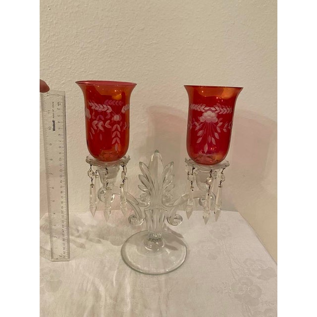 This lovely candelabra was part of my grandmother's cranberry glass collection.. Candles lit inside the cranberry glass...
