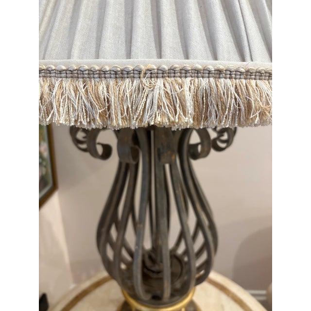 Tall, elegant table lamp with pleated fringed shade