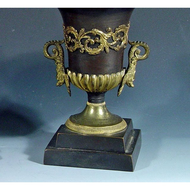 English Bronze and Ormolu Pineapple topped Urns with Reversible Candlestick Tops, Circa 1815-30 The pair of bronze urns...