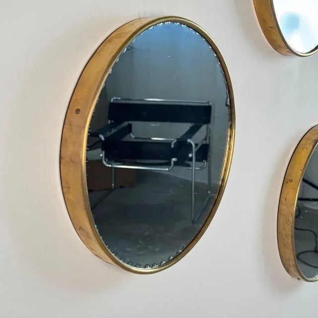 A refined set of three round wall mirrors produced by Cristal Art in Italy during the 1970s. Each mirror features a...