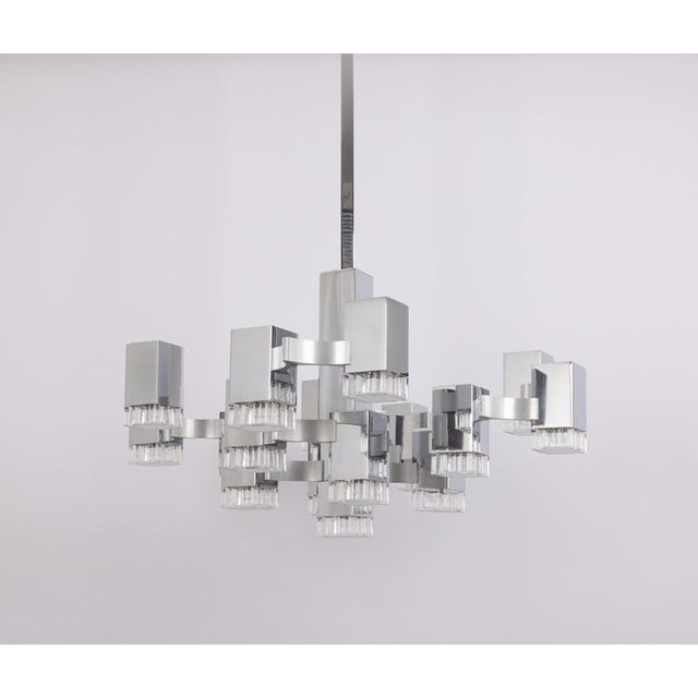Impressive large “cubic” chandelier by italian designer gaetano sciolari, dating from the 1960s/1970s. Its geometric...
