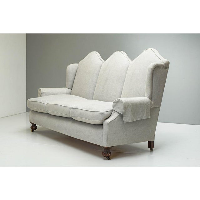 Recently reupholstered 3 seat camel back settee on walnut bun feet. uk circa 1930 h 120cm x w 205cm x d 85cm x sh 52cm...