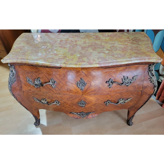 Louis XV style Bombe commode with original beveled marble top. Features intricate marquetry and parquetry wood inlays and...
