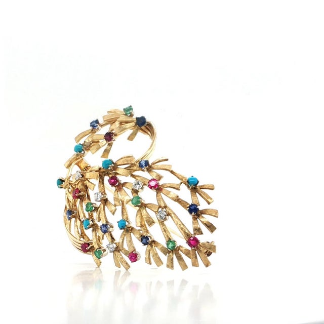 This impressive large brooch is finely crafted in solid 18k yellow gold, designed as an elegant openwork bouquet with...