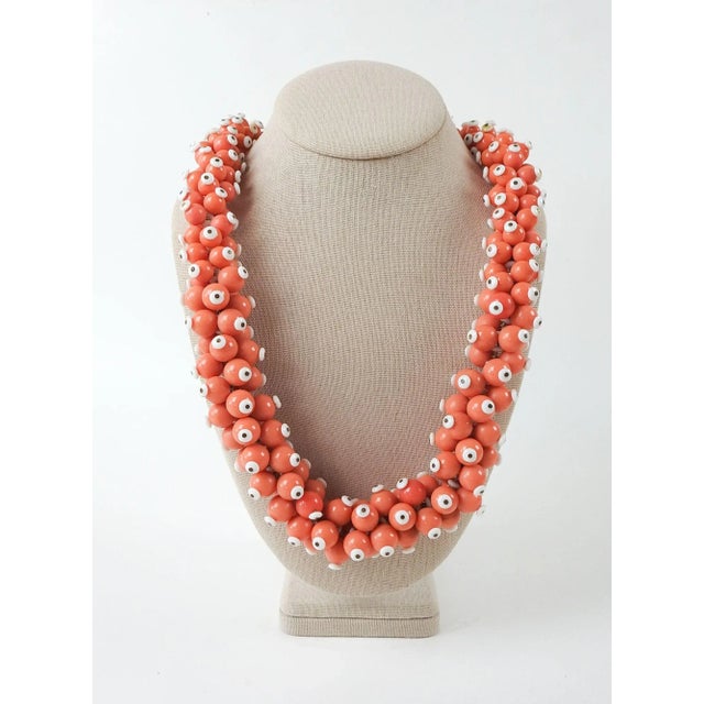 Circa 1960's bold dimensional salmon and white graduated beaded necklace. Measures 27" long, 1" diameter at smallest 1.5"...