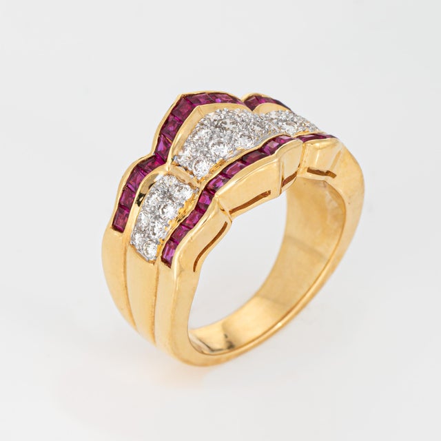 Stylish diamond & ruby band crafted in 18 karat yellow gold (circa 1980s). Calibre cut rubies measure approx. 1.5mm each....