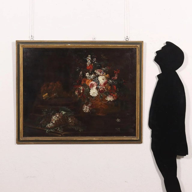 Oil on canvas. Lombard school of the late 1600s-early 1700s.The rich composition features a large bunch of multicolored...