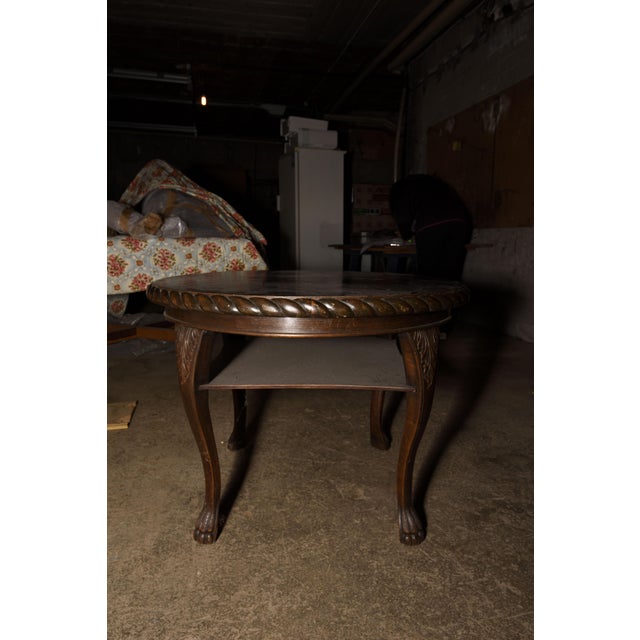 Coffee table round in oak parts in solid and parts furred, with inlay a star on the central and frame worked and carved to...