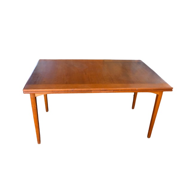 A splendid mid-century dining set by iconic Swedish designer Carl Malmsten, featuring six upholstered blue chairs and an...