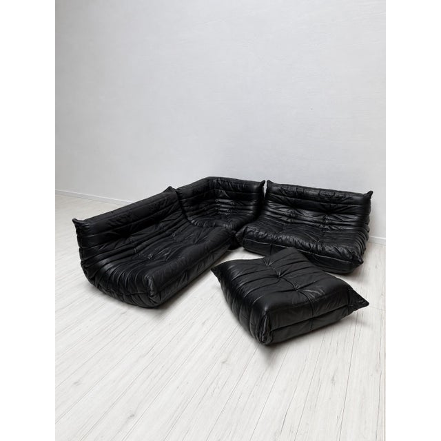 Iconic togo lounge set, designed by michel ducaroy for ligne roset, upholstered in thick and beautifully aged black...