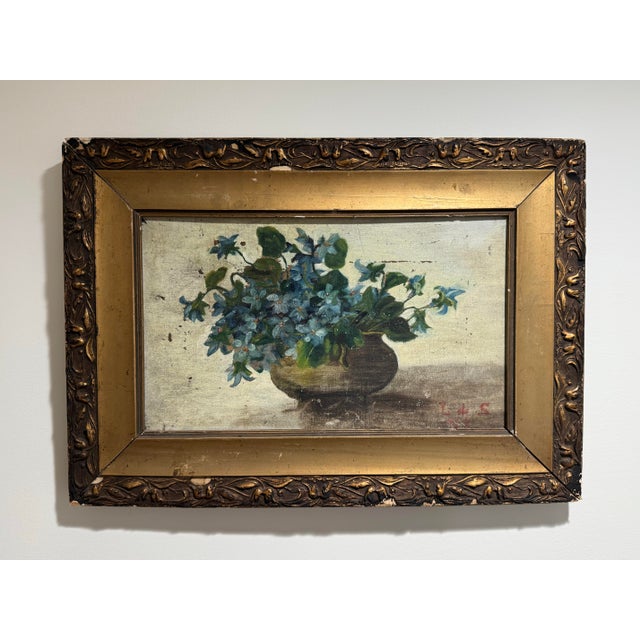 Traditional European antique oil still life of violets or forget-me-nots. The painting has visible craquelure and aging on...