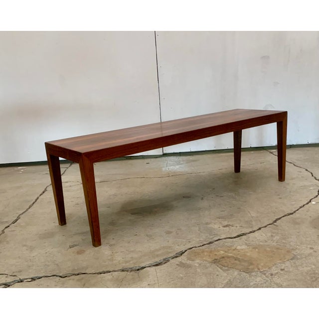 This Severin Hansen Rosewood side table is Identifiably the work of a master designer his iconic slender and tapered table...