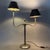 An elegant and dramatic two-armed table lamp in mid-century style, attributed to a 1970s design. Subject and Style:...