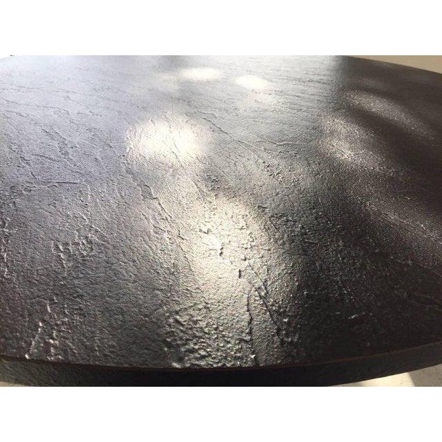 Dramatic linear painted steel center table by Woodard -- may be used as dining table. The circular top is faux slate.