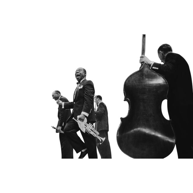 American jazz trumpeter and bandleader Louis 'Satchmo' Armstrong (1900 - 1971), shouts after clarinettist Edmund Hall's...