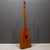 ABOUT A vintage, wooden guitalin. The guitalin features a distinct trapezoidal body and typically has four courses of...