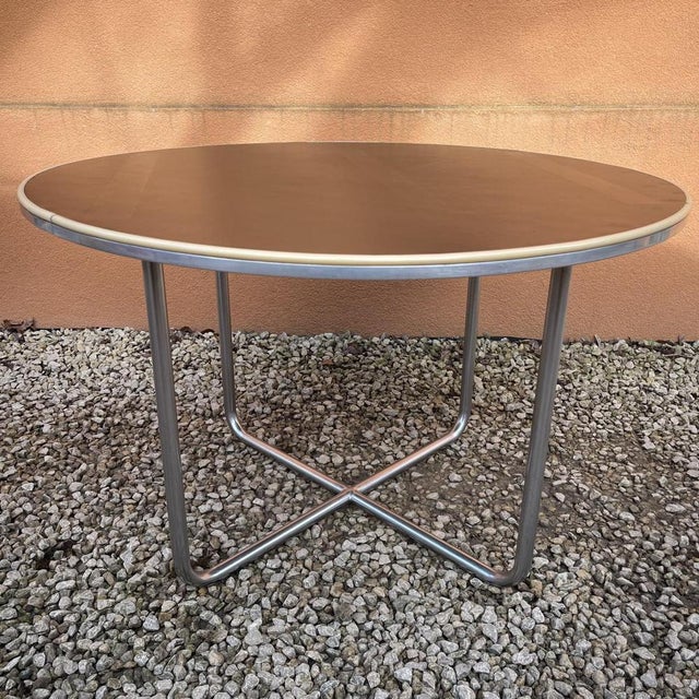 Art deco coffee table with bauhaus modernist accents, reminiscent of the work of marcel breuer. This round table with its...