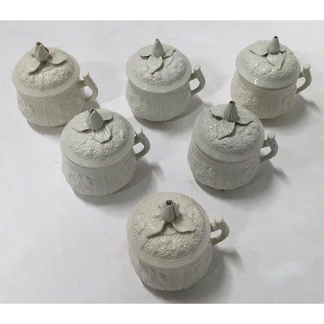 Set of six vintage porcelain floral Mottahedah pot de creme with floral lids and vine handles. Marked "Museum Mottahedah...