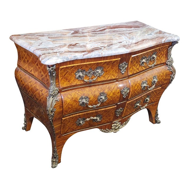 The dresser, with a strongly shaped line, is made of almond wood and entirely inlaid with a marqueterie motif. It is...
