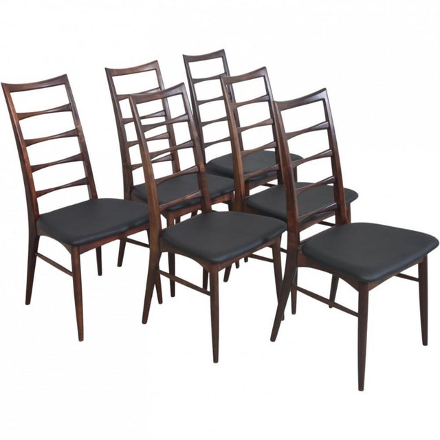 Set of 6 Ib Kofoed Larsen Lis chairs with frames of stained beech and seats of black leather. The chairs are from the...