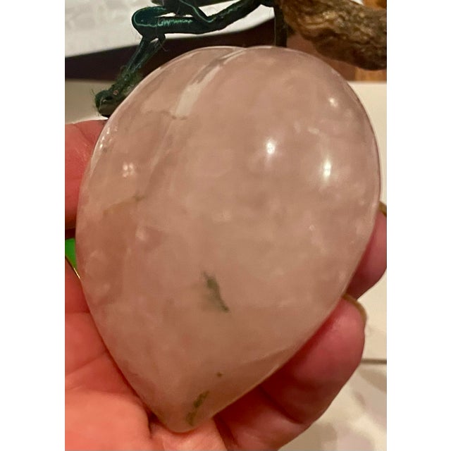 This is a sweet piece of rose quartz that is carved into a plum or peach shape with satin covered wire stems holding green...