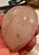 This is a sweet piece of rose quartz that is carved into a plum or peach shape with satin covered wire stems holding green...