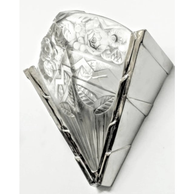 A pair of French Art Deco wall sconces by the French artist " Noverdy ". Molded clear frosted glass shades decorated with...