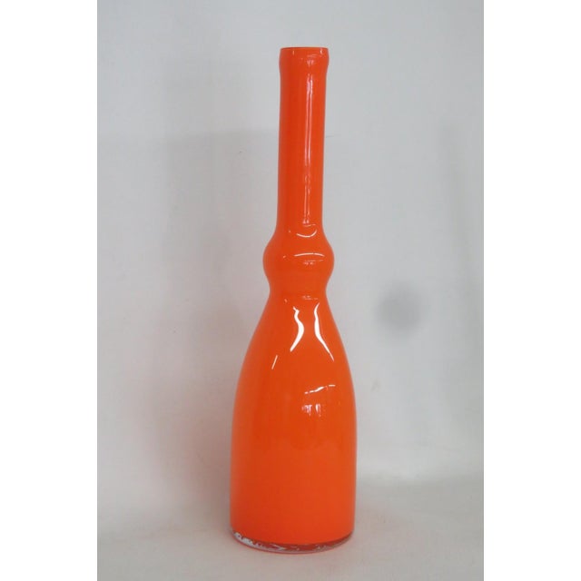 This brilliant Rounded Vase is made of art glass. This gorgeous vase presents a rounded base, a pinched center design, and...