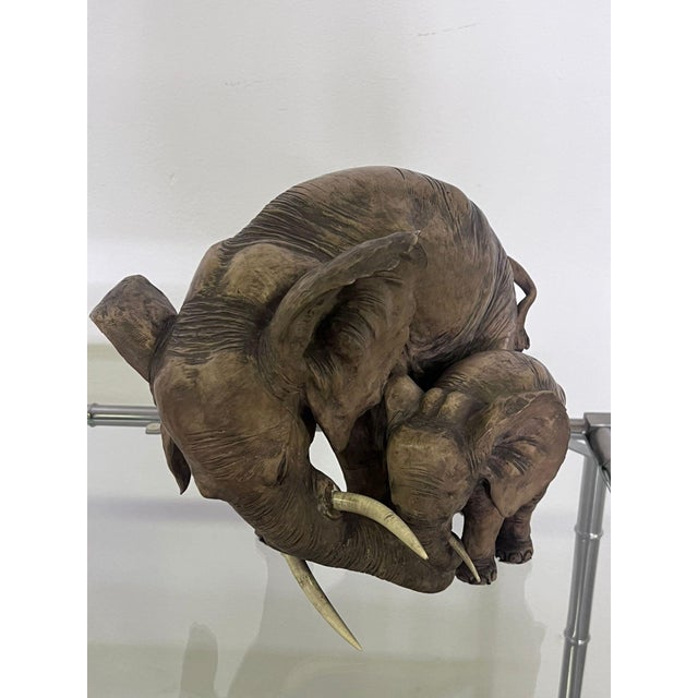 Hand-painted terracotta sculpture depicting a mother and baby elephant dating back to the 1960s.