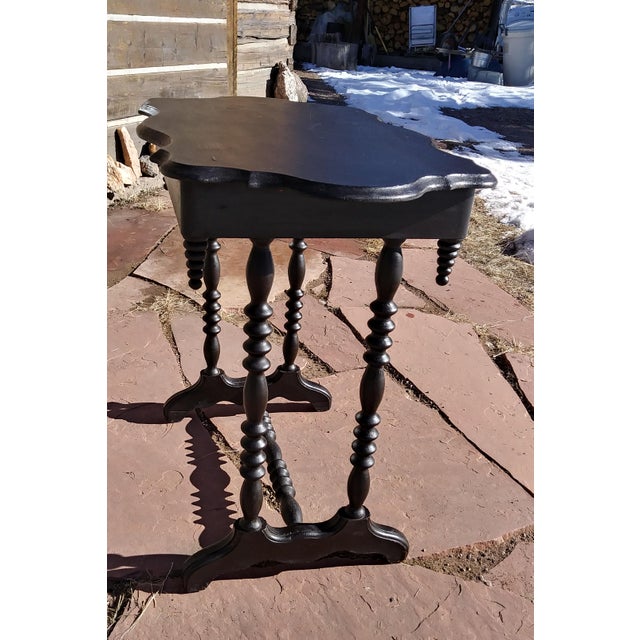 Spindle leg end table with curved table top and feet, spindled bottom brace and icicle-style spindle trim, single drawer.