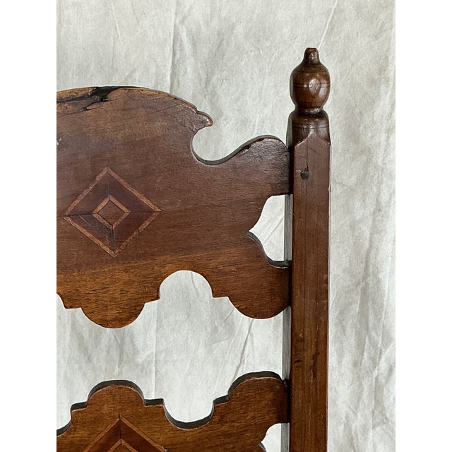 A charming and highly decorative set of six Spanish Colonial Revival dining chairs featuring hand-cut ladderback splats...