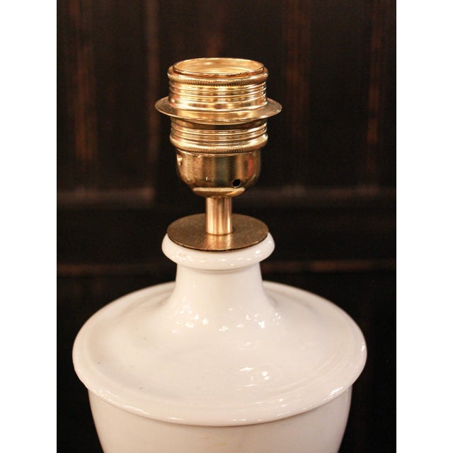 An elegant white ceramic table lamp, crafted in Manises, near Valencia, a town with a long ceramic tradition. Its classic...