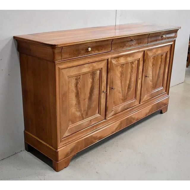 Sideboard in massive Birch and veneer, with over Wood Moldings Dual its three visible edges. It opens with three drawers...