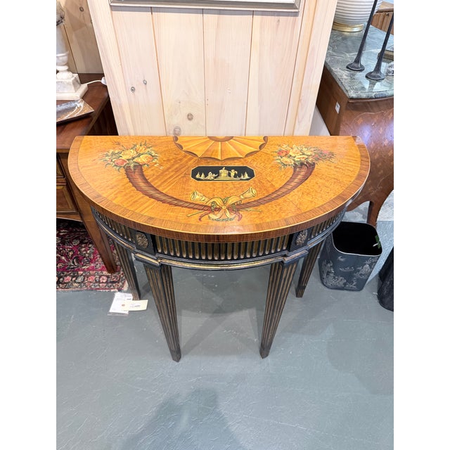 An exceptional antique Neoclassical demilune console table showcasing elaborate marquetry and classical architectural...