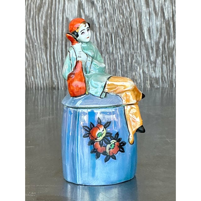 This exquisite vintage Art Deco cigarette jar is a charming fusion of elegance and whimsy, showcasing a beautifully hand-...
