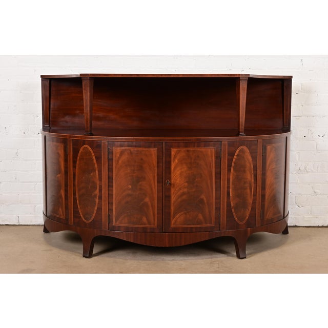 An exceptional Georgian, Hepplewhite, or Federal style sideboard buffet or bar cabinet By Baker Furniture USA, Circa 1940s...