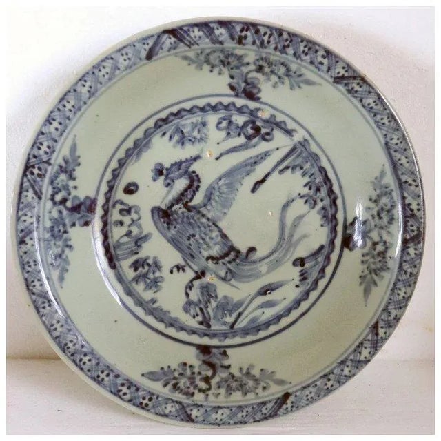 DETAILS An antique Chinese export Swatow ware or Zhangzhou blue and celadon glaze pottery bowl with a phoenix image. With...
