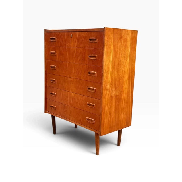Here is a mid-century Danish modern teak tallboy dresser with six drawers. Its clean, compact shape makes it a practical,...