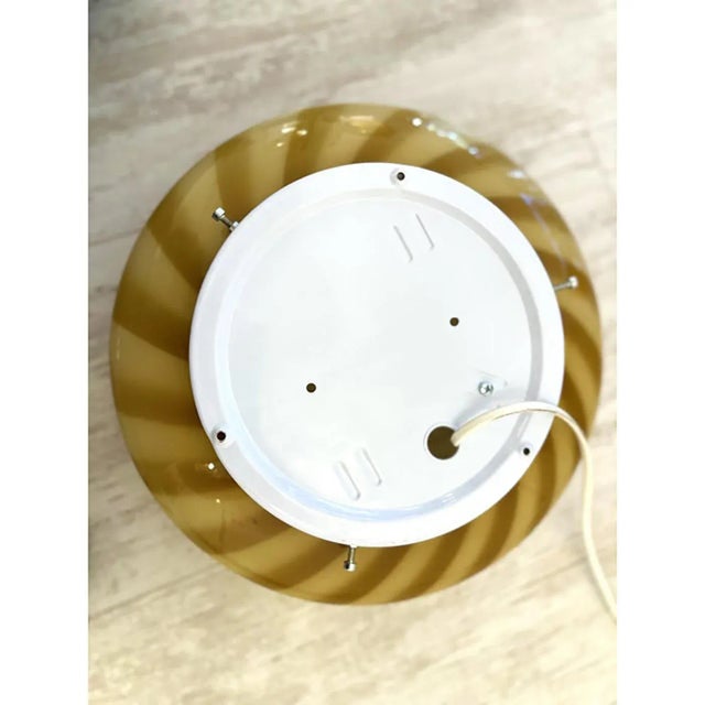 Contemporary milky-white blowing glass with amber "rigadin ritorto" traditional murano working. the base is white so when...